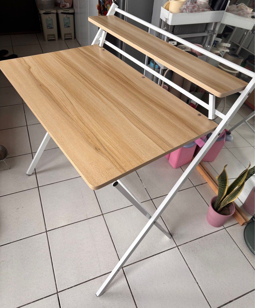 Ofix Folding Study Table with Shelf (Category: Tables & Sets) located in Quezon City. Submitted by gellymart (Listing ID 1415479771, Image 1). Description: Ofix Folding Desk FOR SALE ₱1,400 - 80x60x74 cm - 9/10 condition (minor dents in picture) - sturdy - rfs: downsizing.