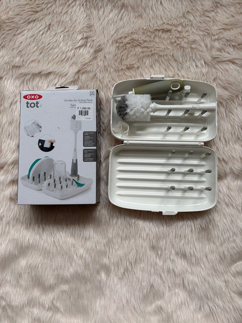OXO Tot On-the-Go Drying Rack (Category: Breastfeeding & Bottle Feeding) located in Cebu City. Submitted by happyheartcebu (Listing ID 1415451393, Image 2). Description: - OXO Tot On-the-Go Drying Rack - Ideal for baby bottles and accessories - Includes a bottle brush - Compact and portable design - Features pegs for bottles and a water-catching tray - Original price: ₱1,295.00 - Convenient for parents on the go.