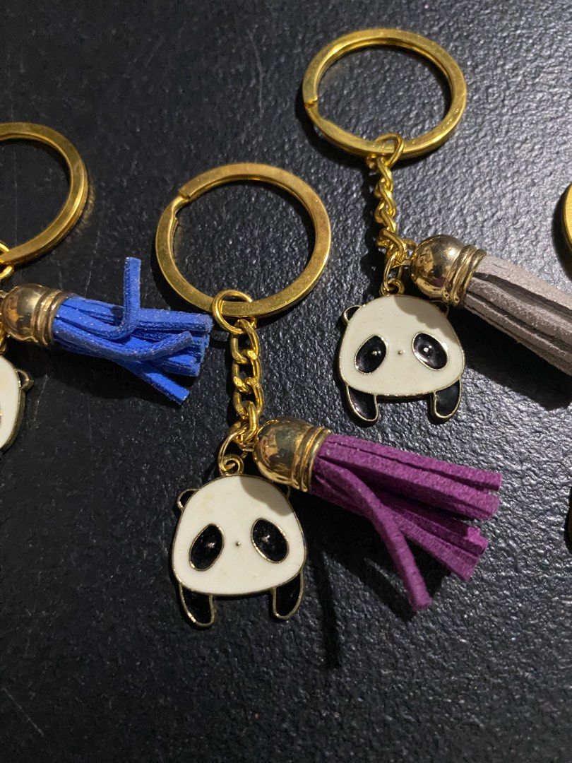 Panda Keychains with Tassels (Category: Charms) located in Valenzuela. Submitted by emg.everythingmustgo (Listing ID 1415555836, Image 3). Description: 100 each - Adorable panda keychain. - Gold-colored ring and chain. - Features a cute panda charm. - Comes with a colorful tassel. - Tassel colors: blue, purple, gray, pink, and green. - Great for keys or bags. - Ideal gift for panda lovers!.