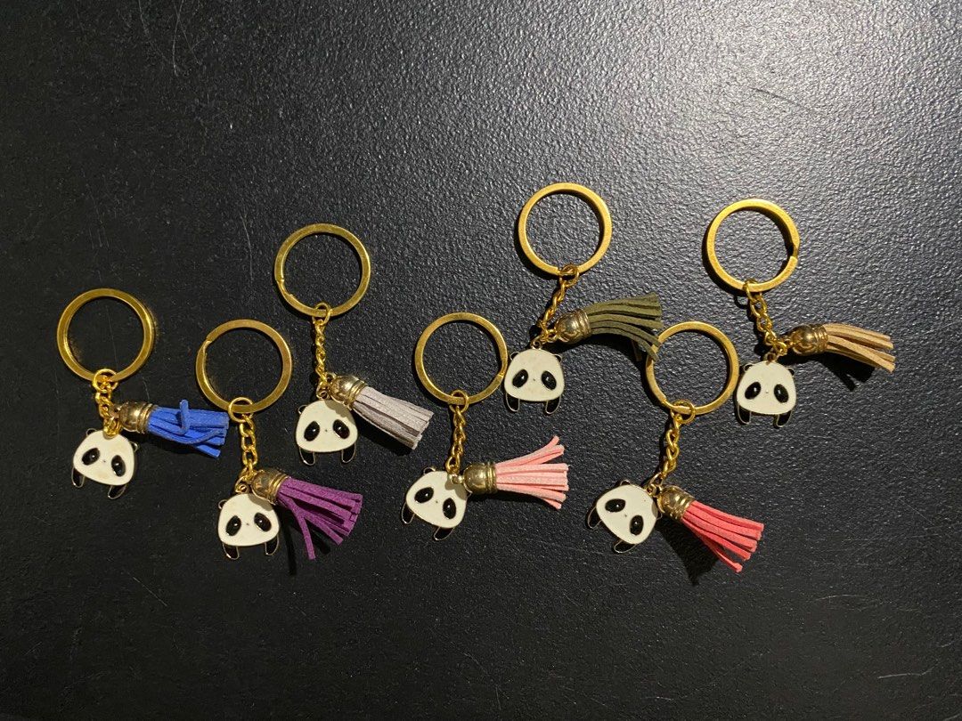 Panda Keychains with Tassels (Category: Charms) located in Valenzuela. Submitted by emg.everythingmustgo (Listing ID 1415555836, Image 1). Description: 100 each - Adorable panda keychain. - Gold-colored ring and chain. - Features a cute panda charm. - Comes with a colorful tassel. - Tassel colors: blue, purple, gray, pink, and green. - Great for keys or bags. - Ideal gift for panda lovers!.