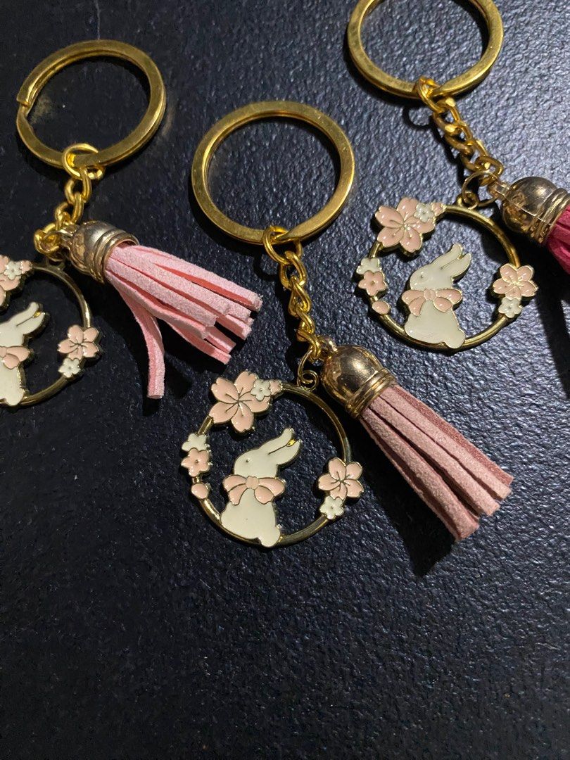 Rabbit Flower Keychains with Tassels (Category: Charms) located in Valenzuela. Submitted by emg.everythingmustgo (Listing ID 1415553928, Image 3). Description: 100 each - Adorable rabbit and flower design. - Gold-colored ring and chain. - Comes with a colorful tassel (pink, blue, brown). - Adds a charming touch to your keys or bags..