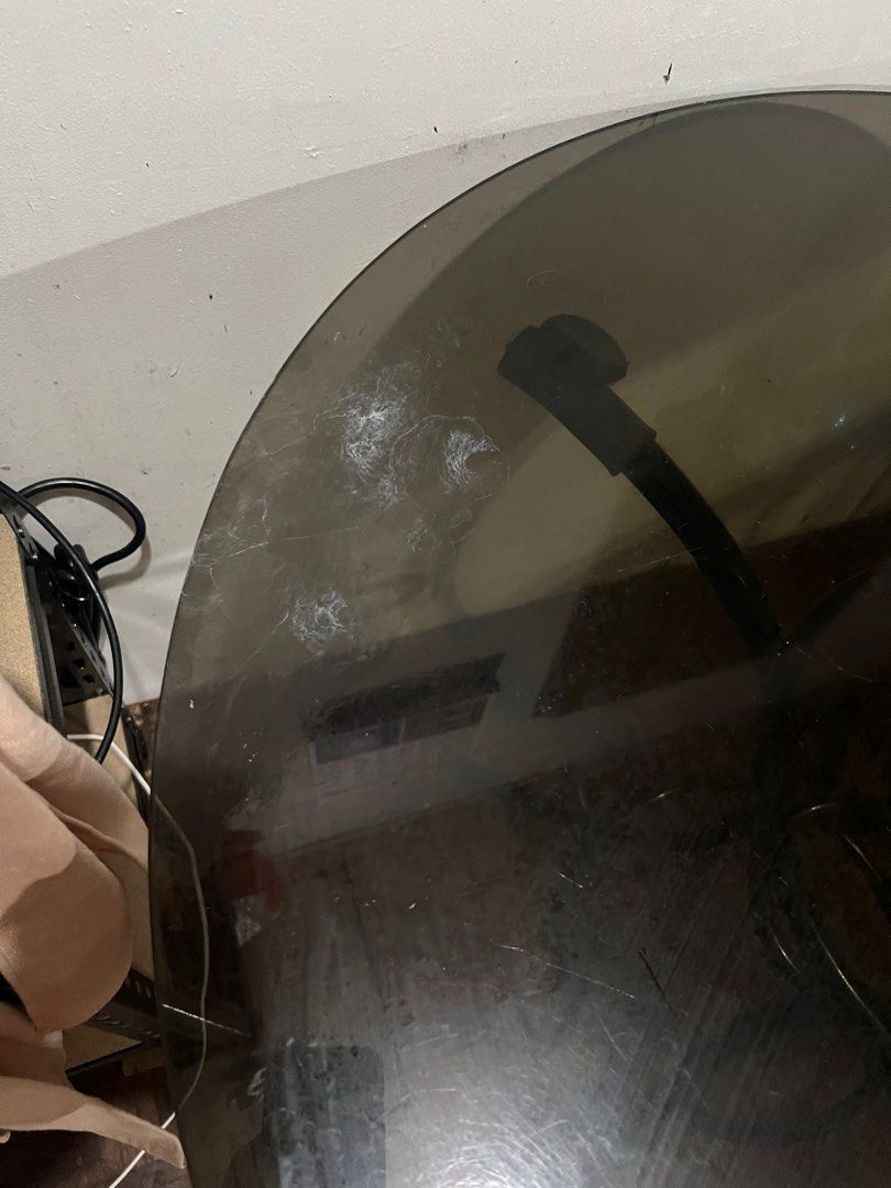 Round Glass Top Table (Category: Tables & Sets) located in Rizal. Submitted by gonzalesliza58 (Listing ID 1415510011, Image 3). Description: - Round table - Black metal frame - Tinted glass top - Central support ring, three legs - Shows some wear on glass top - Perfect for small dining or side table.