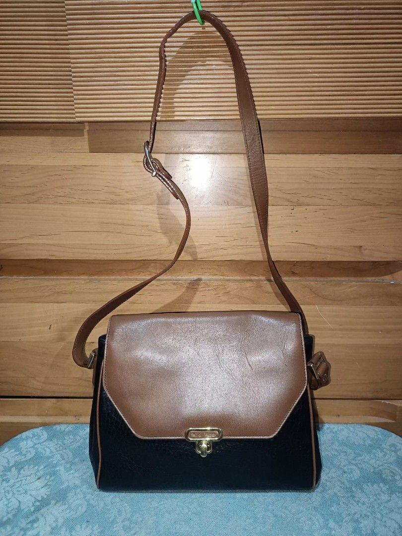 Rudolph Valentino Sling Bag (Category: Luxury Bags & Wallets) located in Baguio. Submitted by iyaberong48242 (Listing ID 1415434418, Image 1). Description: - Rudolph Valentino Shoulder Bag - Two-tone design: Brown flap, Black body - Gold-tone clasp - Adjustable long strap - Multiple interior compartments - Includes a zippered pocket - Authentic Ralph Valentino branding on clasp and inside -Meduim Size..