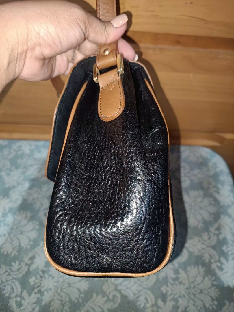 Rudolph Valentino Sling Bag (Category: Luxury Bags & Wallets) located in Baguio. Submitted by iyaberong48242 (Listing ID 1415434418, Image 3). Description: - Rudolph Valentino Shoulder Bag - Two-tone design: Brown flap, Black body - Gold-tone clasp - Adjustable long strap - Multiple interior compartments - Includes a zippered pocket - Authentic Ralph Valentino branding on clasp and inside -Meduim Size..