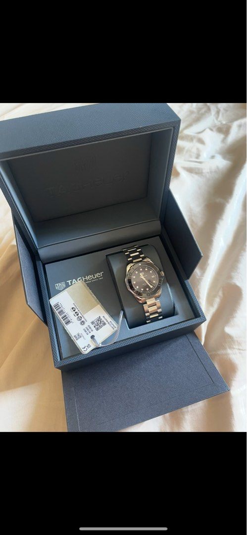 TAG Heuer Aquaracer Watch (Category: Luxury Watches) located in Pasig City. Submitted by clairedaniellett (Listing ID 1415435490, Image 1). Description: - TAG Heuer Aquaracer watch - Stainless steel bracelet - Black dial mother of pearl - Rotating bezel - Includes original box, papers, and tags.
