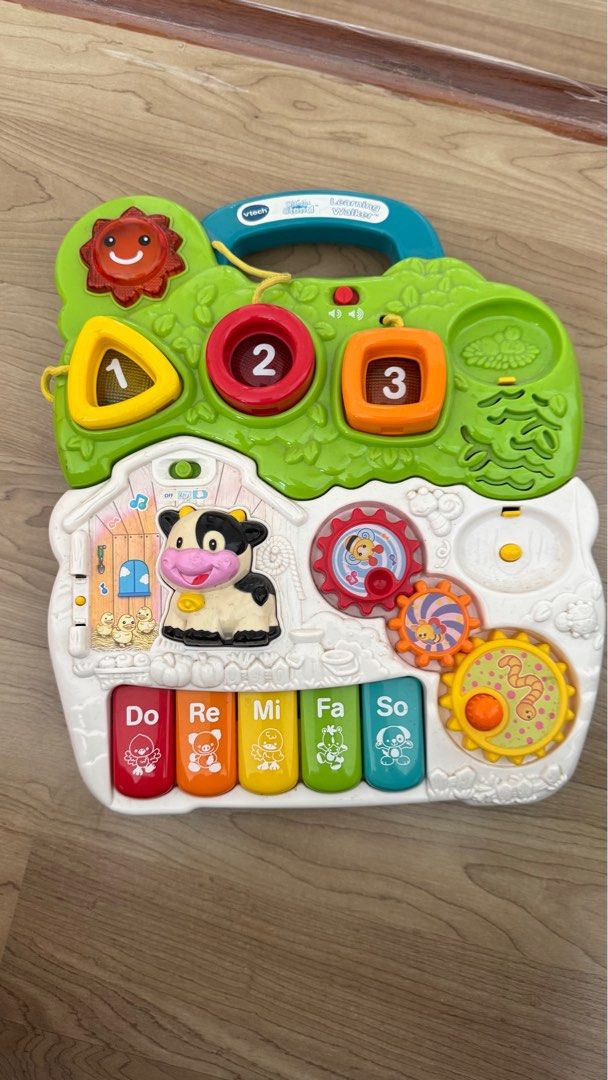 VTech Learning Walker (Category: Infant Playtime) located in Kuala Lumpur. Submitted by mhanifz (Listing ID 1415487379, Image 2). Description: - VTech Learning Walker - Detachable activity panel with numbers, shapes, and musical notes - Features interactive elements like a cow, gears, and piano keyboard - Designed to help babies learn and develop motor skills - Easy-to-push handle.