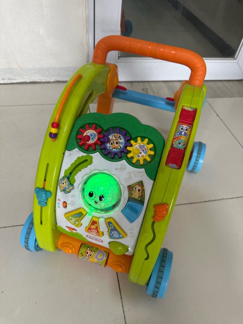 VTech Sit-to-Stand Learning Walker (Category: Infant Playtime) located in San Juan City. Submitted by v7_cd (Listing ID 1415444749, Image 1). Description: - VTech Sit-to-Stand Learning Walker - Interactive and fun for babies - Features colorful lights, buttons, and gears - Sturdy design with easy-move wheels - Includes a handle for walking support - Helps develop motor skills - Teaches shapes, colors, and music.