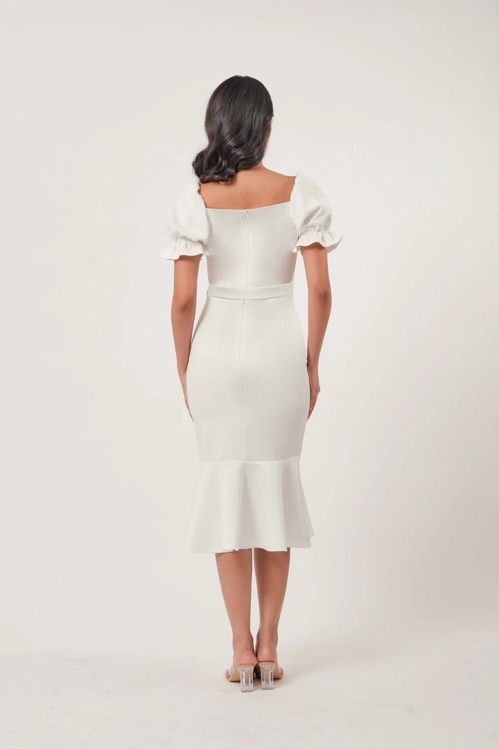 White Midi Dress with Puff Sleeves (Category: Dresses) located in Quezon City. Submitted by rossyl_22 (Listing ID 1415594778, Image 3). Description: - White midi dress - Sweetheart neckline - Short puff sleeves - Fitted bodice - Defined waist - Mermaid hem with front slit - Smooth, likely stretchy fabric - Ideal for special occasions.