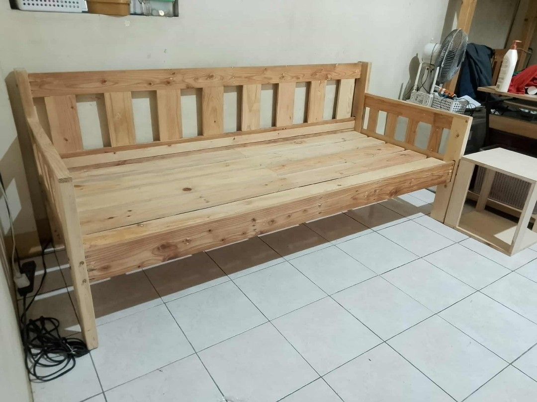 Wooden Sofa Bed with Storage Drawers (Category: Sofas) located in Manila. Submitted by jovetph. (Listing ID 1415518164, Image 1). Description: Handcrafted wooden sofa bed with natural finish. Features storage drawers and armrests. Matching side table available. Ideal for small spaces..