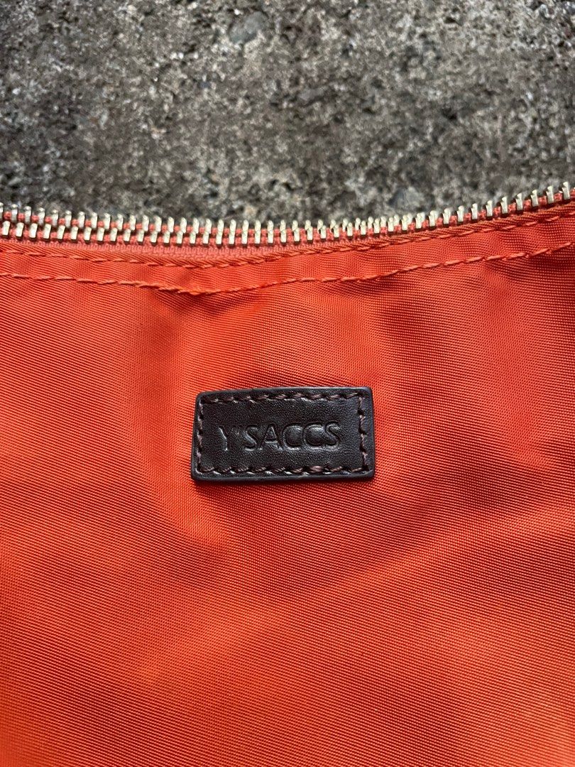 Y's Sacs Orange Tote Bag (Category: Tote Bags) located in Alfonso. Submitted by assortedg3 (Listing ID 1415594707, Image 2). Description: - Y's Sacs orange tote bag - Zip closure - Brown leather accents - Interior pocket - Rectangular shape - Two shoulder straps - Brown fabric lining - Includes interior tag.
