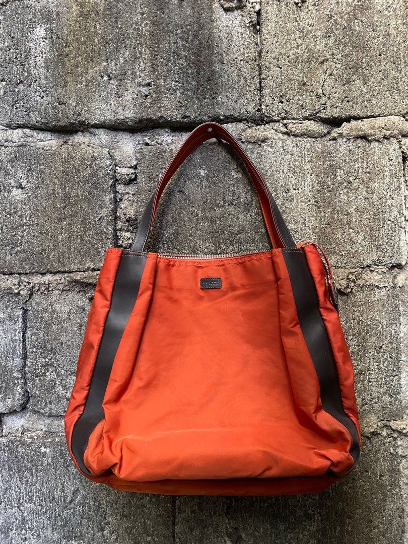 Y's Sacs Orange Tote Bag (Category: Tote Bags) located in Alfonso. Submitted by assortedg3 (Listing ID 1415594707, Image 1). Description: - Y's Sacs orange tote bag - Zip closure - Brown leather accents - Interior pocket - Rectangular shape - Two shoulder straps - Brown fabric lining - Includes interior tag.