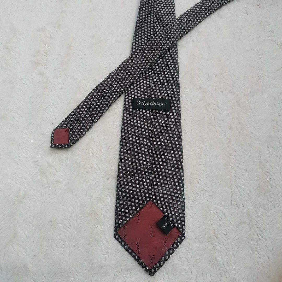 Yves Saint Laurent Silk Tie (Category: Ties) located in Manila. Submitted by titojay (Listing ID 1415455757, Image 1). Description: - Yves Saint Laurent tie - Silk material - Black and white square pattern - Features red lining with YSL logo - Ideal for formal and business occasions.