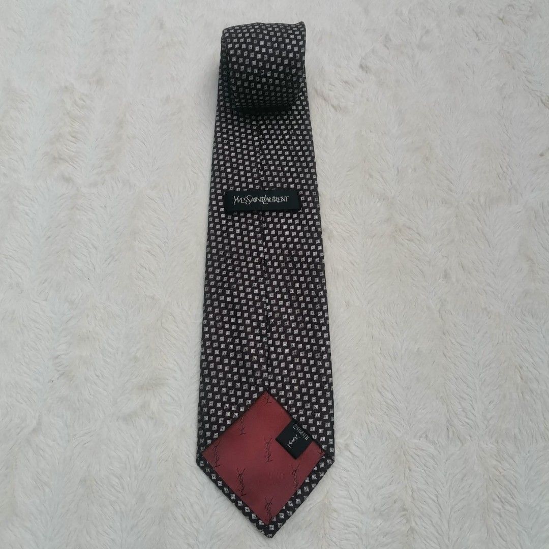 Yves Saint Laurent Silk Tie (Category: Ties) located in Manila. Submitted by titojay (Listing ID 1415455757, Image 2). Description: - Yves Saint Laurent tie - Silk material - Black and white square pattern - Features red lining with YSL logo - Ideal for formal and business occasions.