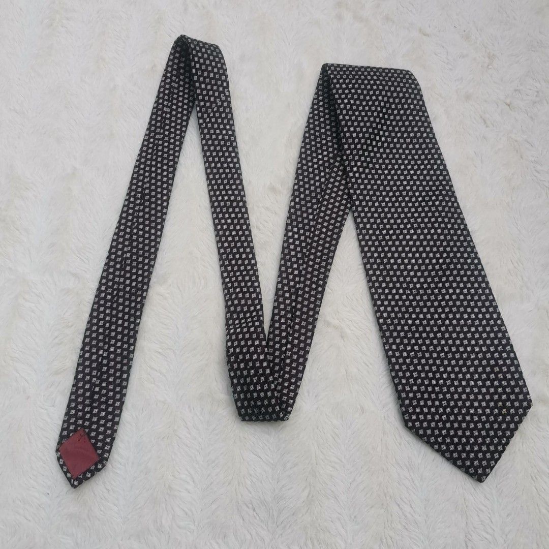 Yves Saint Laurent Silk Tie (Category: Ties) located in Manila. Submitted by titojay (Listing ID 1415455757, Image 3). Description: - Yves Saint Laurent tie - Silk material - Black and white square pattern - Features red lining with YSL logo - Ideal for formal and business occasions.