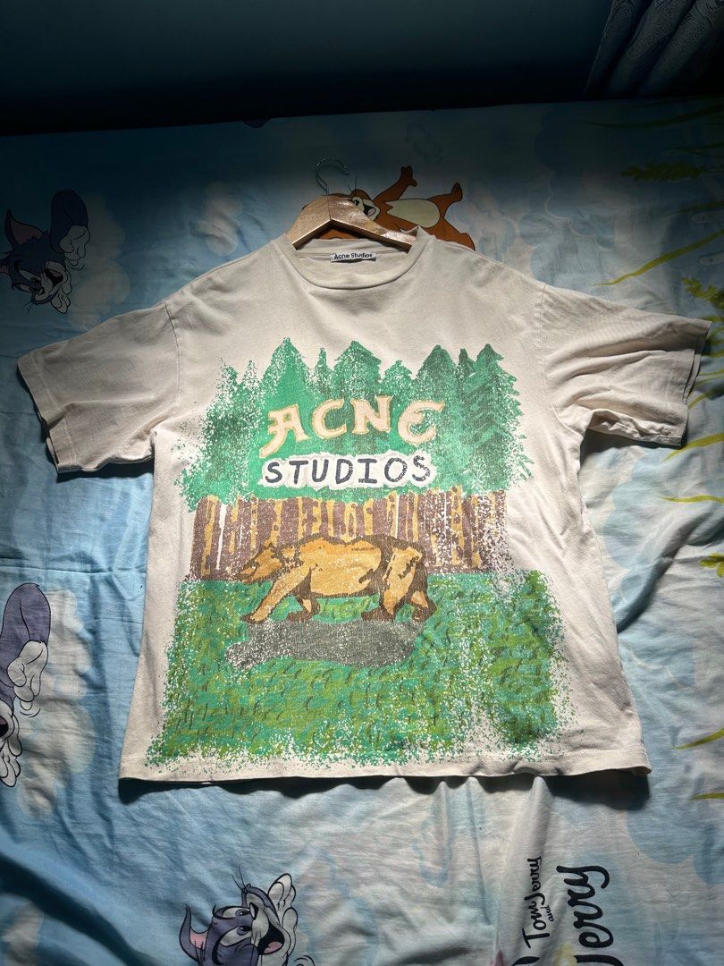 Acne Studios Graphic Tee (Category: Tshirts & Polo Shirts ) located in Manila. Submitted by migiboy (Listing ID 1415670213, Image 1). Description: - Acne Studios graphic tee - Size: S - Material: 100% cotton - Made in Portugal - Features a unique graphic design 23x27 Dimension 9.5 Cr No issue.