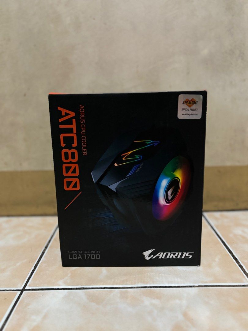 AORUS ATC800 CPU Cooler (Category: Computer Parts) located in Marikina City. Submitted by coyimportant (Listing ID 1415699675, Image 1). Description: - AORUS ATC800 CPU cooler - Compatible with LGA 1700 - Features RGB lighting - AORUS logo fan - Includes cooler and accessories - Box design: Black with orange accents.