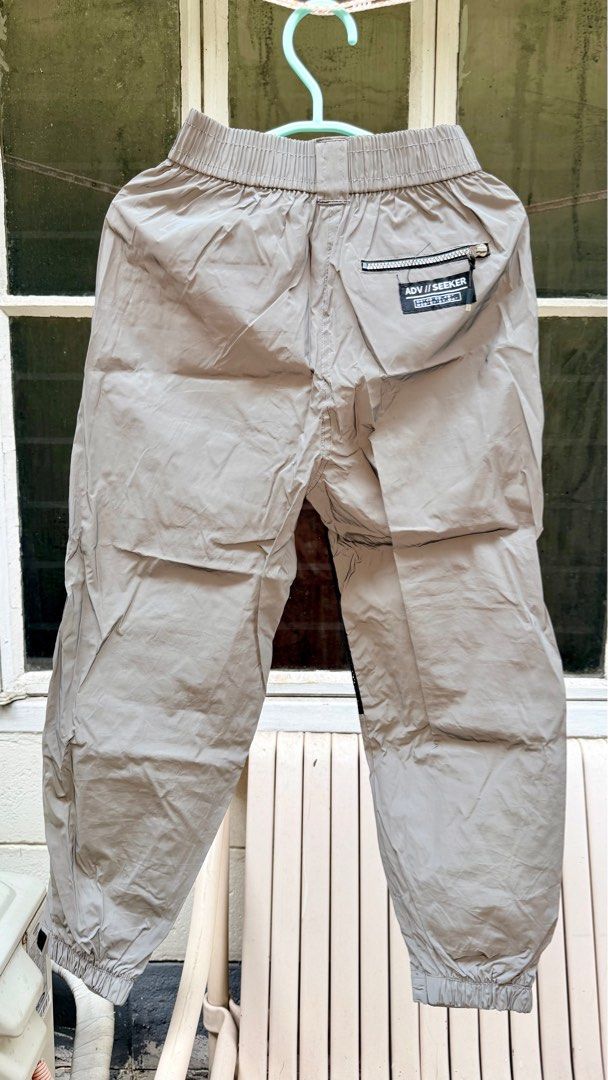 Bershka Cargo Pants - Size S (Category: Jeans) located in Pasig City. Submitted by prioritylaine (Listing ID 1415678935, Image 2). Description: Bershka cargo pants in size S. Features a light grey color with black mesh detailing on the sides. Includes two cargo pockets on the front and a zippered pocket at the back. The pants have an elastic waistband and cuffs. Made in Vietnam. With slight dirt, washable.