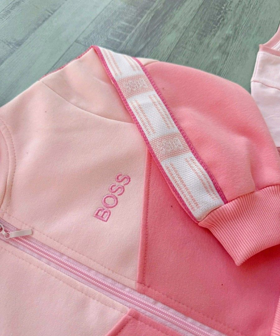 Boss Kids' Pink Tracksuit Set (Category: Babies & Kids Fashion) located in Manila. Submitted by aleicollection2 (Listing ID 1415814147, Image 3). Description: Pink tracksuit set for kids. Includes a zip-up hoodie, a short-sleeved t-shirt, and matching pants. The hoodie and pants feature white stripes down the sides. The t-shirt has the word "BOSS" printed on it. Perfect for casual wear. Available sizes 👇🏻 1-2y✅ 2-3y✅ 3-4y✅ 4-5y✅ 6-7y✅ Made in V