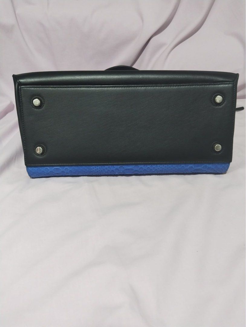 Celine Handbag with Blue Snakeskin (Category: Luxury Bags & Wallets) located in Manila. Submitted by cooldolphin-c87b62 (Listing ID 1415708915, Image 3). Description: - Authentic Celine handbag - Black leather and blue snakeskin exterior - Top handle design - Secure zippered closure - Interior lined with black fabric - Convenient back pocket - Protective metal feet on the bottom - Celine logo visible inside.