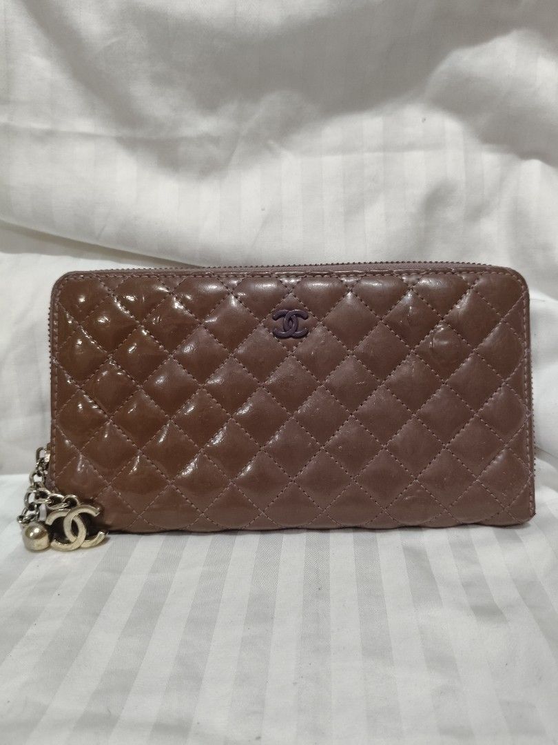 Chanel Quilted Zip Around Wallet (Category: Luxury Bags & Wallets) located in Lucena. Submitted by gwpsns_2026 (Listing ID 1415666487, Image 1). Description: - Authentic Chanel wallet - Brown color - Quilted design - Chanel logo - Zip closure - Serial number sticker included - Interior: lighter purple - Attached charm.