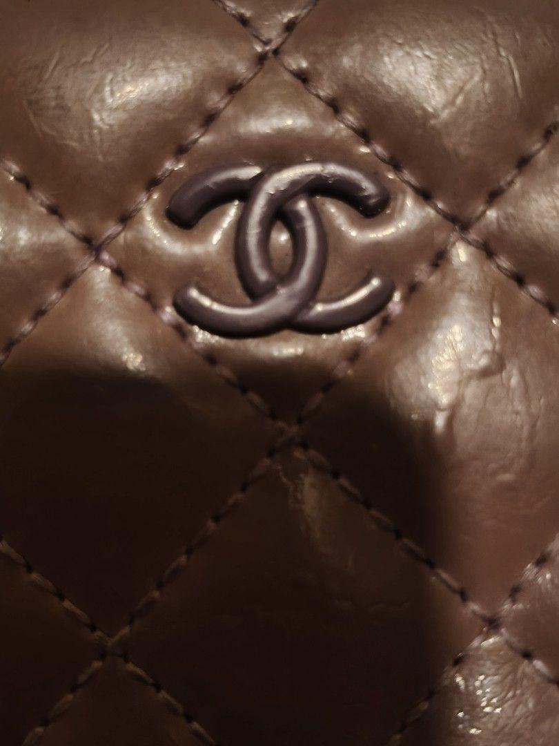 Chanel Quilted Zip Around Wallet (Category: Luxury Bags & Wallets) located in Lucena. Submitted by gwpsns_2026 (Listing ID 1415666487, Image 2). Description: - Authentic Chanel wallet - Brown color - Quilted design - Chanel logo - Zip closure - Serial number sticker included - Interior: lighter purple - Attached charm.