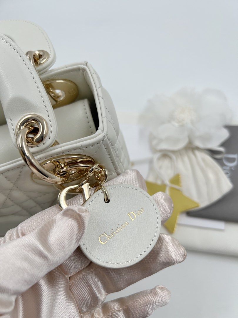 ⚜️Christian Dior - Lady Dior Mini bag (Category: Luxury Bags & Wallets) located in Makati City. Submitted by 90sangel (Listing ID 1415778445, Image 2). Description: •Item: Lady Dior mini bag in white🍦🍨🐚⚜️🤍 •Size: Mini •Condition: As New! No hidden issue. Light gold hardware ~ rare and hard to find *Includes dustbag, cards & big paperbag ~ .