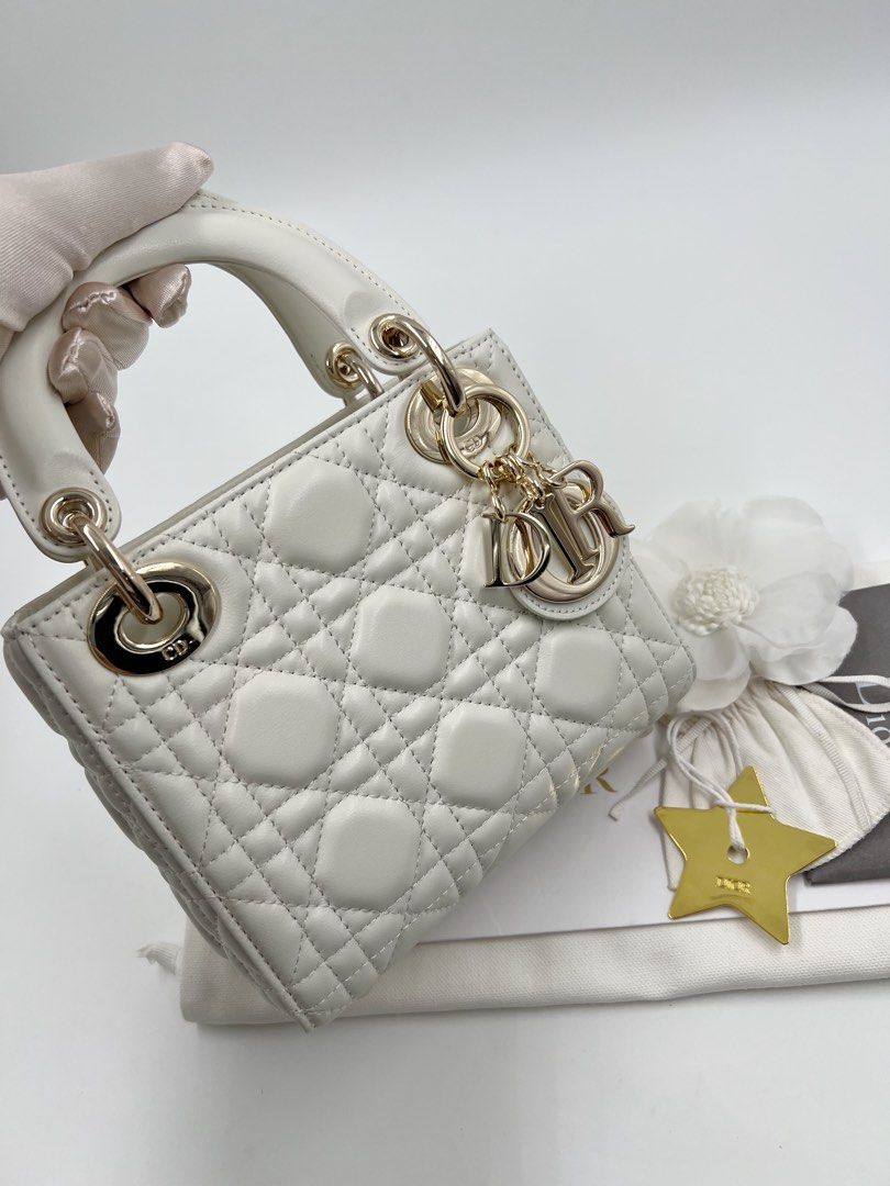 ⚜️Christian Dior - Lady Dior Mini bag (Category: Luxury Bags & Wallets) located in Makati City. Submitted by 90sangel (Listing ID 1415778445, Image 3). Description: •Item: Lady Dior mini bag in white🍦🍨🐚⚜️🤍 •Size: Mini •Condition: As New! No hidden issue. Light gold hardware ~ rare and hard to find *Includes dustbag, cards & big paperbag ~ .