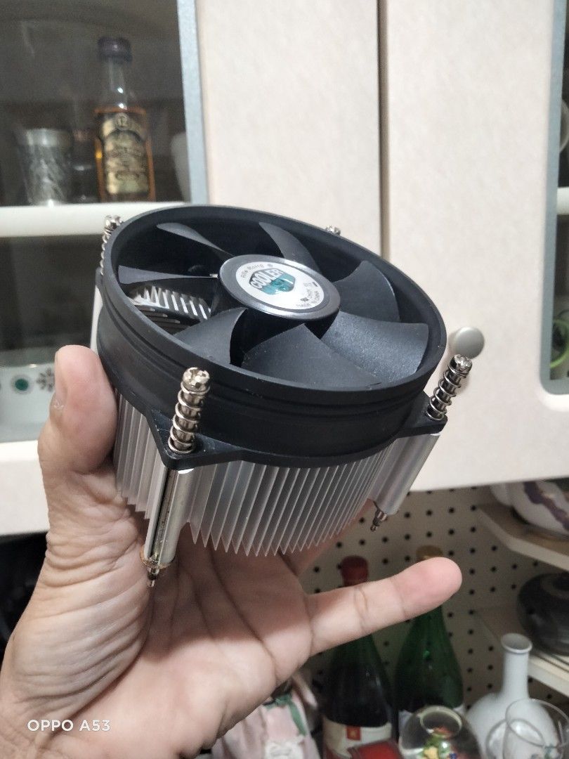 Cooler Master CPU Cooler (Category: Computer Parts) located in Carmona. Submitted by rpute (Listing ID 1415628425, Image 3). Description: Cooler Master CPU cooler with a black fan and silver heatsink. Features a circular fan design with multiple blades. Includes a connector for power. The heatsink has a series of fins for heat dissipation. The cooler is designed to be mounted on a CPU..