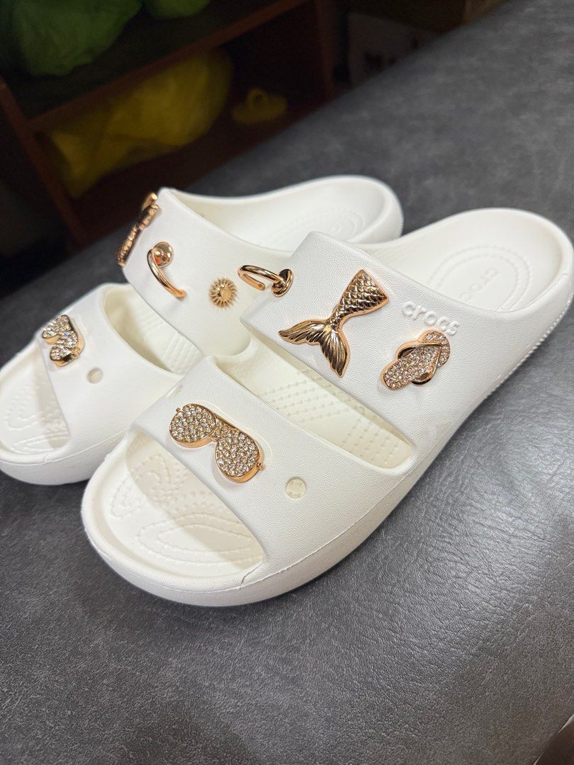 Crocs Sandals with Jibbitz Charms (Category: Flats & Sandals) located in Manila. Submitted by thegreat21 (Listing ID 1415727040, Image 2). Description: White Crocs sandals with Jibbitz charms. Features gold-colored charms. Double-strap design. Size W8/M6. Good as new, once used not my style of double strap. .