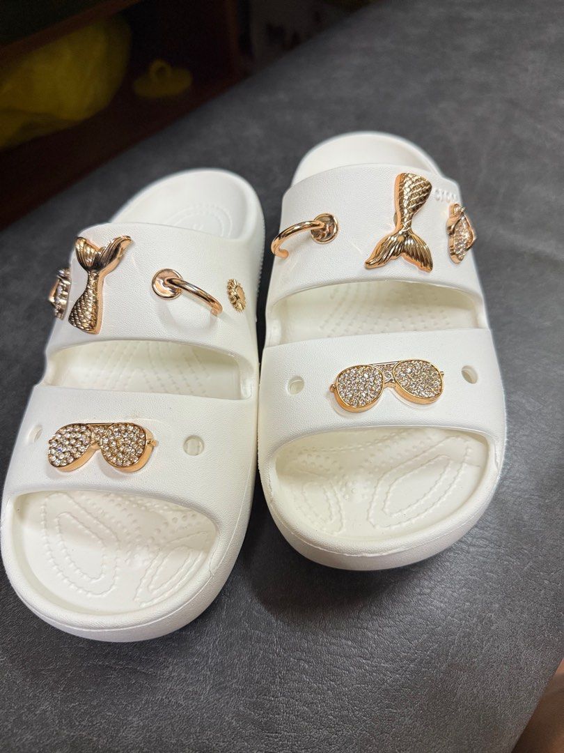 Crocs Sandals with Jibbitz Charms (Category: Flats & Sandals) located in Manila. Submitted by thegreat21 (Listing ID 1415727040, Image 1). Description: White Crocs sandals with Jibbitz charms. Features gold-colored charms. Double-strap design. Size W8/M6. Good as new, once used not my style of double strap. .