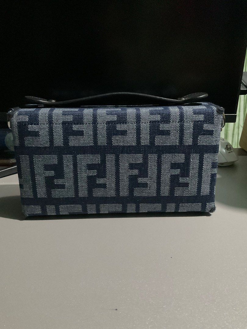 Fendi Denim Jacquard Soft Trunk Baguette Bag (Category: Luxury Bags & Wallets) located in Cabuyao City. Submitted by gerlieluxurycloset2024 (Listing ID 1415740554, Image 2). Description: Brand: Fendi Color: Blue Material: Denim and Microfiber Fabric Condition: light used with visible scratches sa hardware Coded: ✅✅ Inclusions: dust bag,paper works only. Price is still negotiable please dm me for your offer.