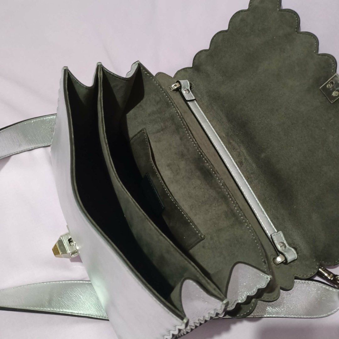 Fendi Silver Floral Embellished Handbag (Category: Luxury Bags & Wallets) located in Manila. Submitted by cooldolphin-c87b62 (Listing ID 1415759164, Image 3). Description: - Silver Fendi handbag - Floral embellishments - Top handle and detachable shoulder strap - Multiple interior compartments and small pocket - Scalloped edge design - Made in Italy.