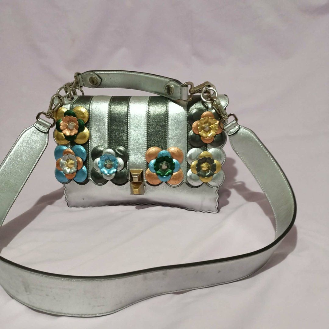 Fendi Silver Floral Embellished Handbag (Category: Luxury Bags & Wallets) located in Manila. Submitted by cooldolphin-c87b62 (Listing ID 1415759164, Image 1). Description: - Silver Fendi handbag - Floral embellishments - Top handle and detachable shoulder strap - Multiple interior compartments and small pocket - Scalloped edge design - Made in Italy.
