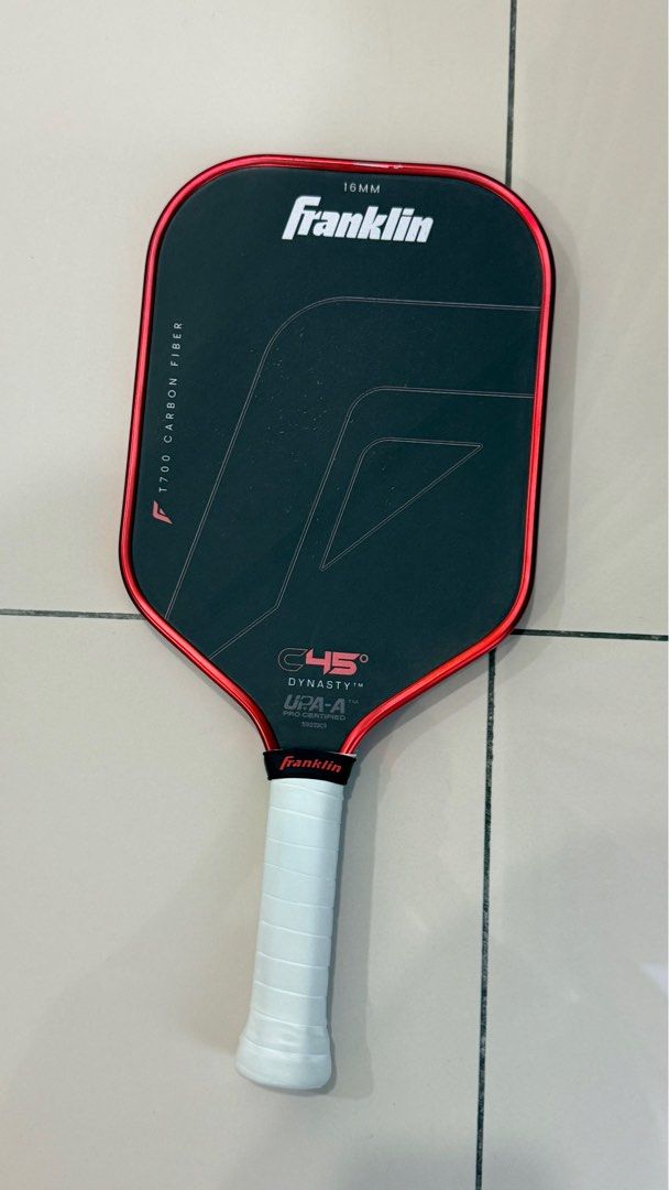 Franklin C45 (Category: Racket & Ball Sports) located in Georgetown. Submitted by fxpixelstudio (Listing ID 1415744285, Image 2). Description: This paddle has been protected with edge tape from day one of use. The visible marks along the edge are not caused by court contact or impact. They occurred during the removal/replacement of the edge tape, where a small amount of the original paint lifted with the adhesive. 👉 No impact to performance, str