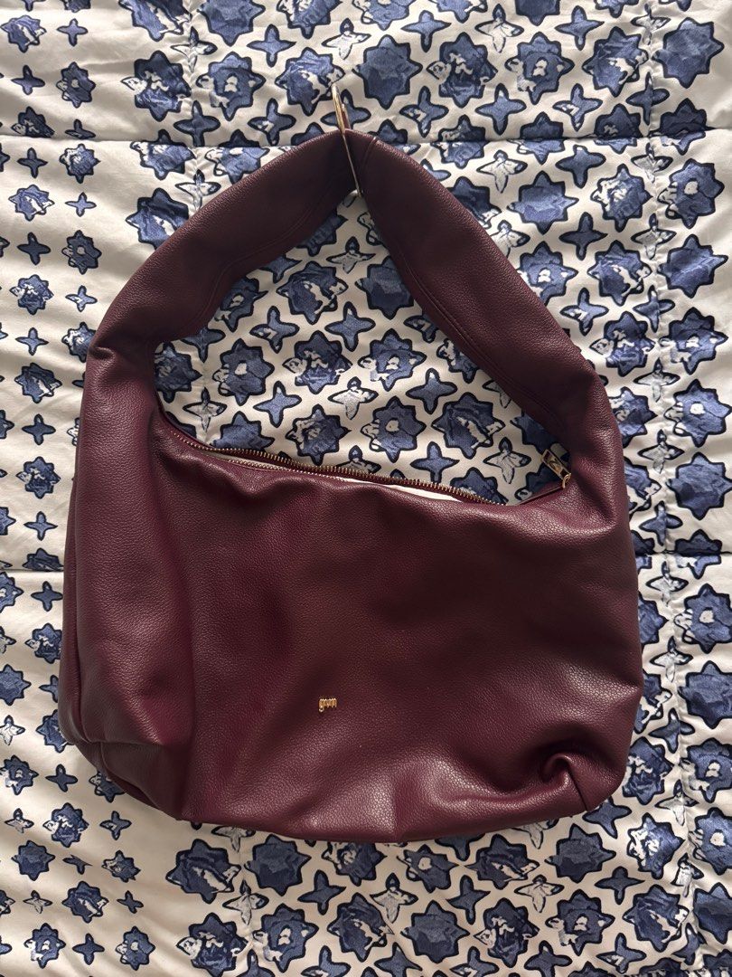 GVN Burgundy Hobo Bag (Category: Shoulder Bags) located in Manila. Submitted by declutters137 (Listing ID 1415653743, Image 1). Description: - Burgundy shoulder bag - Zipper closure - Gold-colored logo - Single shoulder strap - White interior lining - Textured material Used once Selling low RFS; not my style & decluttering.