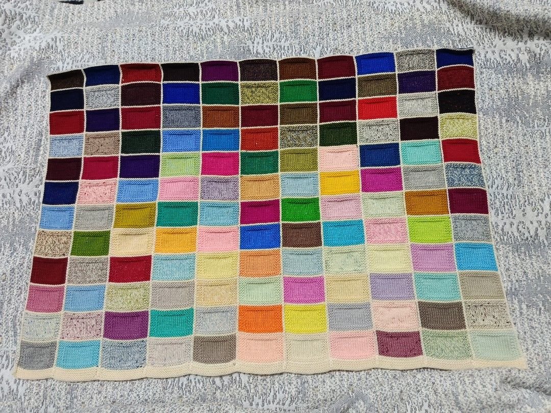 Handmade Patchwork Blanket (Category: Cushions & Throws) located in Karangan. Submitted by khaifira1412 (Listing ID 1415810481, Image 2). Description: - Handmade patchwork blanket - Colorful design with various rectangular patches - Colors include blue, green, red, and yellow - Cream-colored border - Size reference available in the photo.