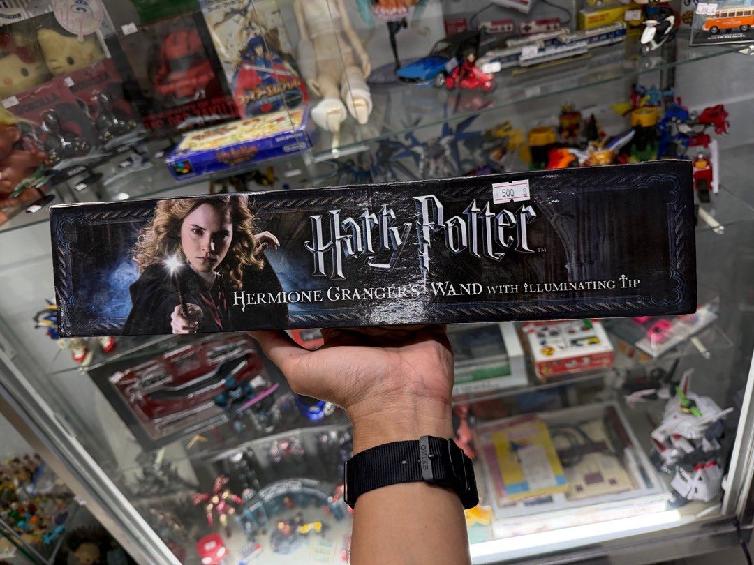 Harry Potter Hermione Granger Wand (Category: Western Merchandise) located in Makati City. Submitted by japankycollection (Listing ID 1415658213, Image 1). Description: - Hermione Granger's wand - Features an illuminating tip (UNTESTED) - Comes in original box - Box has image of Hermione Granger and Harry Potter logo - Wand is brown plastic.