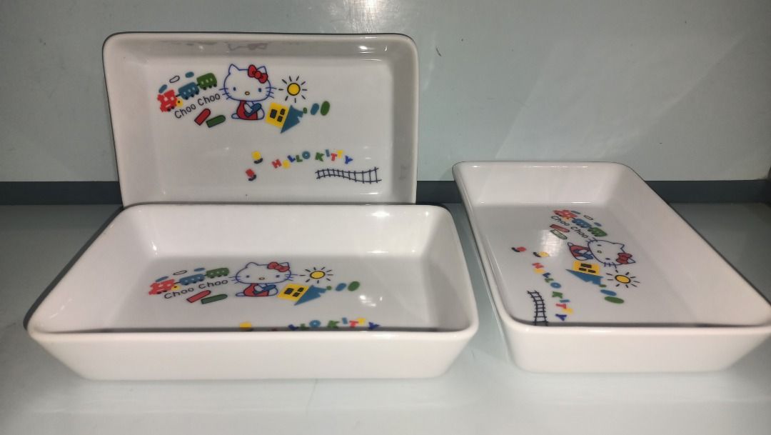 Hello Kitty Ceramic Trinket (Category: Other Kitchenware & Tableware) located in Munoz. Submitted by larryc1212 (Listing ID 1415772085, Image 1). Description: - Set of three Kitty ceramic trinket. - Features a white base with a colorful Kitty design. - Each tray measures approximately 7.5 inches long and 5 inches wide. - Ideal for serving snacks or as decorative pieces. P180 per piece Item may include some scratches due to age, as is were is basi
