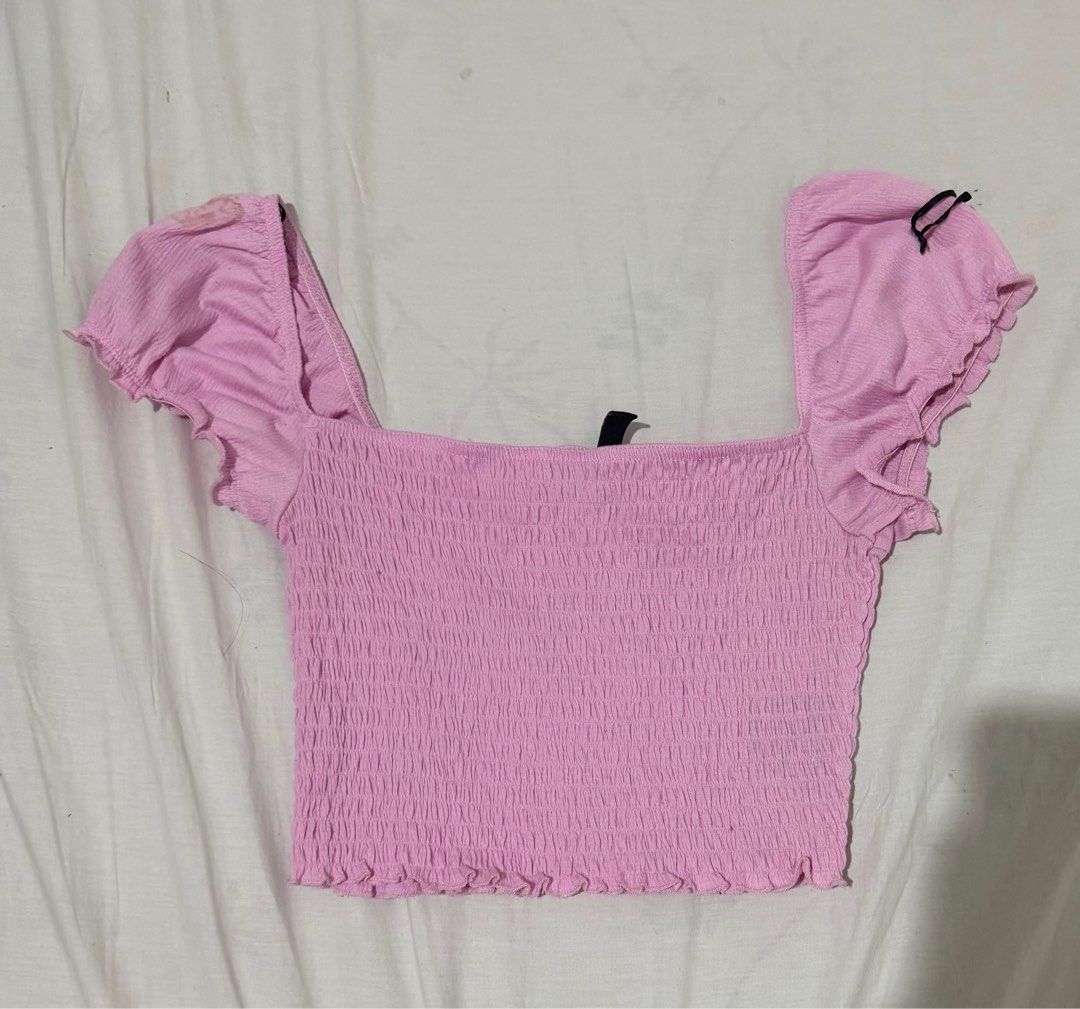H&M Pink Smocked Crop Top (Category: Sleeveless) located in Caloocan City. Submitted by sunooberi (Listing ID 1415754258, Image 1). Description: - H&M crop top - Square neckline - Ruffled sleeves - Smocked bodice - Light pink color - Brand new with tag - Great with high-waisted bottoms.