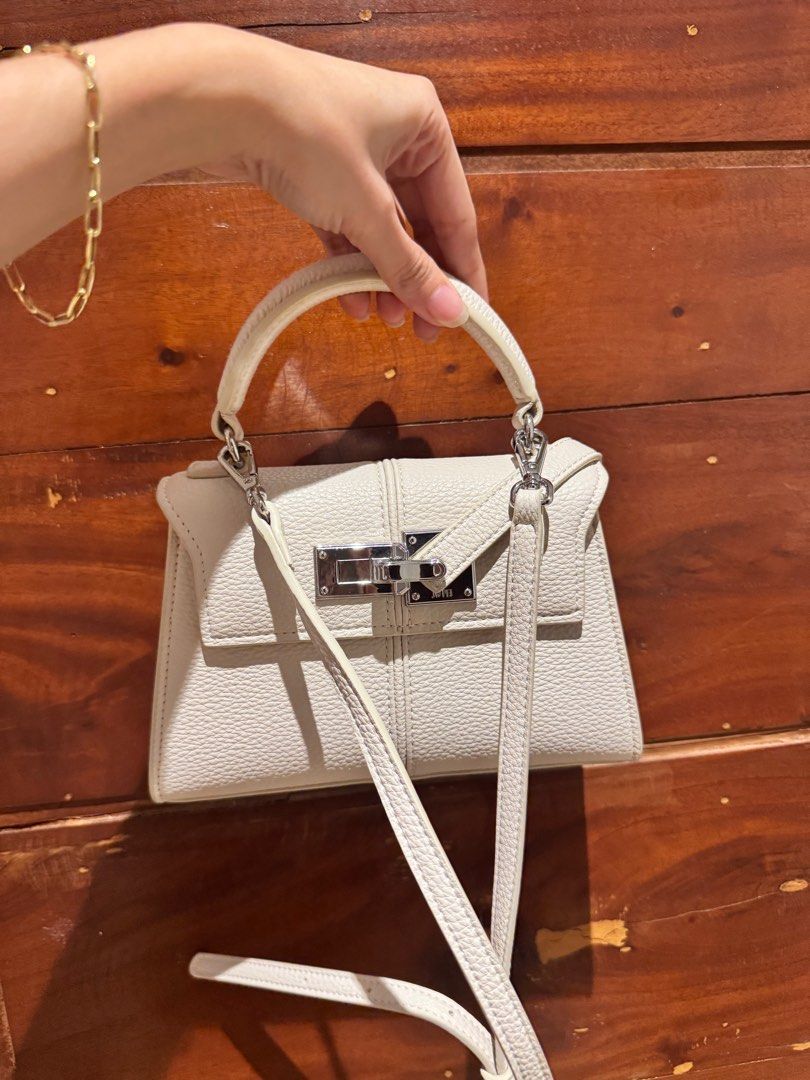 JWPEI Elise Too Handle Bag - White Small (Category: Luxury Bags & Wallets) located in Cagayan de Oro. Submitted by declutteringszn (Listing ID 1359740140, Image 2). Description: ✨ Barely used JW PEI top-handle bag ✨ | ₱5,200 on website, selling it for ₱2600! 🛍️ In excellent condition, almost like new. Details Major Material：Vegan Leather Lining Material：Vegan Leather 7.87” W × 5.31” H × 2.76” D (20cm x 13.5cm x 7cm) Handle Drop: 2.56” (6.5cm) Sh