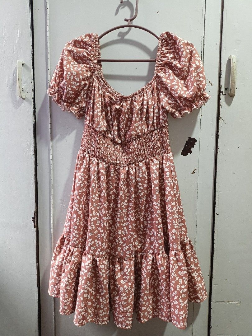 Kids Dress Preloved (Category: Babies & Kids Fashion) located in Cainta. Submitted by sjprelovedbotique (Listing ID 1415667942, Image 2). Description: White dress with a vibrant floral print featuring orange and blue flowers and leaves. It has short sleeves and a tie detail at the neckline. The dress has a slightly curved hemline..