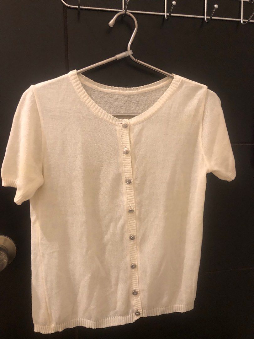 Knitted Blouse (Category: Coats, Jackets and Outerwear) located in Pasig City. Submitted by boundless93 (Listing ID 1415638171, Image 1). Description: - White short sleeve cardigan - Button closure - Round neckline - Ribbed hem and cuffs - Silver buttons - Versatile for various outfits.