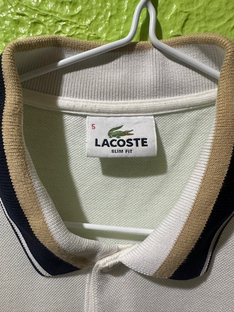 Lacoste Slim Fit Polo Shirt (Category: Tshirts & Polo Shirts ) located in Manila. Submitted by skydave196 (Listing ID 1415800449, Image 2). Description: - Lacoste polo shirt - Slim fit - Color: White - Collar with navy and tan stripes - Striped cuffs (navy and tan) - Short sleeves - Lacoste logo on chest - Size 5 -dimes 20/28.