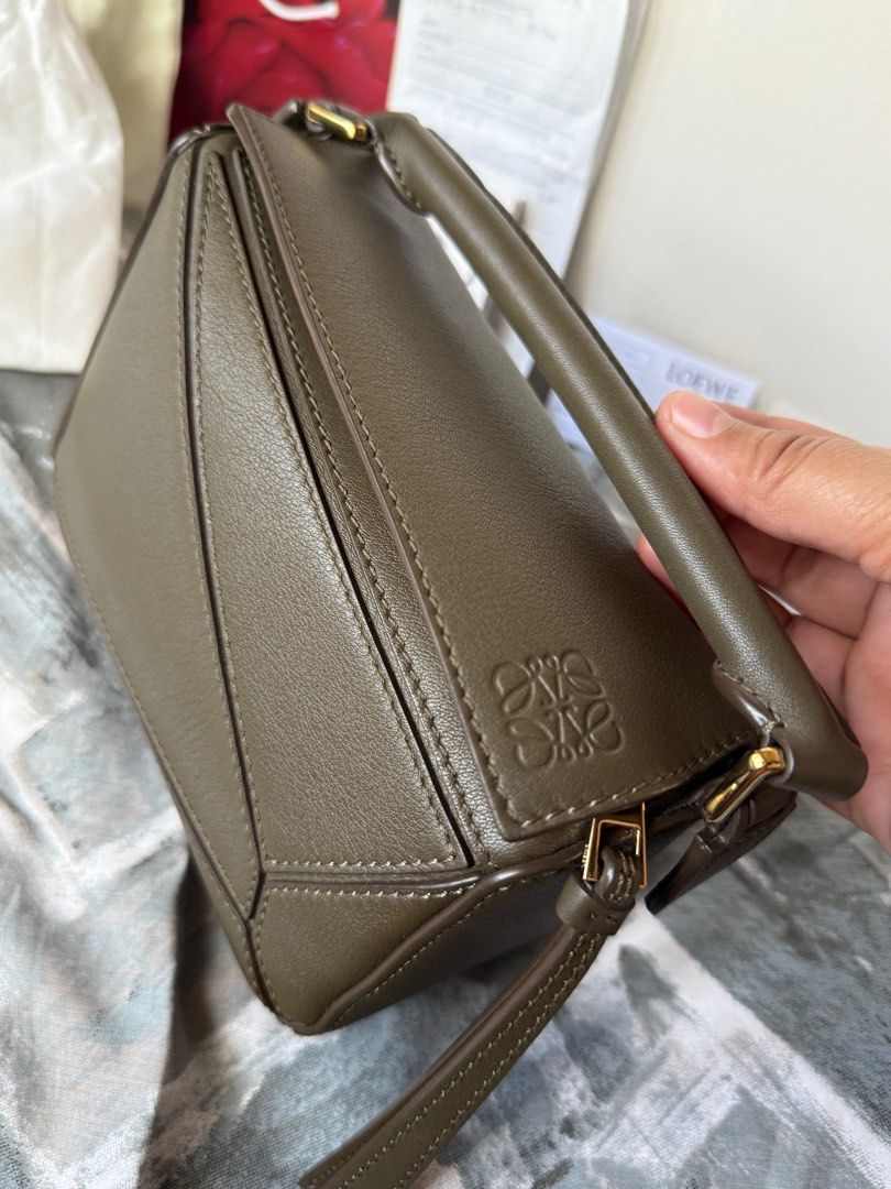 Loewe Mini Puzzle Bag w/ store receipt (Category: Luxury Bags & Wallets) located in Talisay. Submitted by justgeeeee (Listing ID 1415656716, Image 2). Description: - with store receipt (bought in Greenbelt), dust bag, tags, box, paper bag. - Top handle and comes with a detachable shoulder strap - almost brandnew condition (i take absolute care of my bags) ❤️ GUARANTEED AUTHENTIC CURRENT STORE/BOUTIQUE PRICE OF MINI PUZZLE BAG NOW IS AROUND 160K P