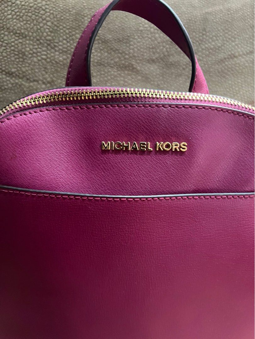 MK Michael Kors Emmy Large Dome Backpack - Magenta (Category: Backpacks) located in Quezon City. Submitted by bfindsph_26 (Listing ID 1415799457, Image 3). Description: Michael Kors Emmy Large Dome Backpack Color: Magenta (also listed as Deep Burgundy) Material: Saffiano leather Used only 2x like new condition — no major flaws. Zip-around top closure, adjustable shoulder straps, and gold-tone hardware. Bought in the USA #MichaelKors #MKBackpack #