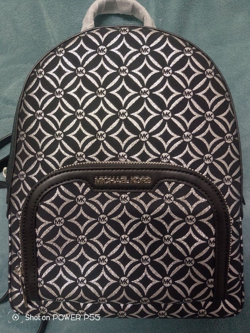 Michael Kors Jaycee MD Zip Pkt Backpack (Category: Backpacks) located in Binan City. Submitted by stuffshop29 (Listing ID 1415674532, Image 1). Description: Bought in Italy Authentic Michael Kors Jaycee backpack. Features a black and silver geometric pattern. Includes a front zip pocket and adjustable straps. The interior is lined with the Michael Kors logo. Comes with tags and care instructions. The hardware is silver-toned. Model number is 35F4