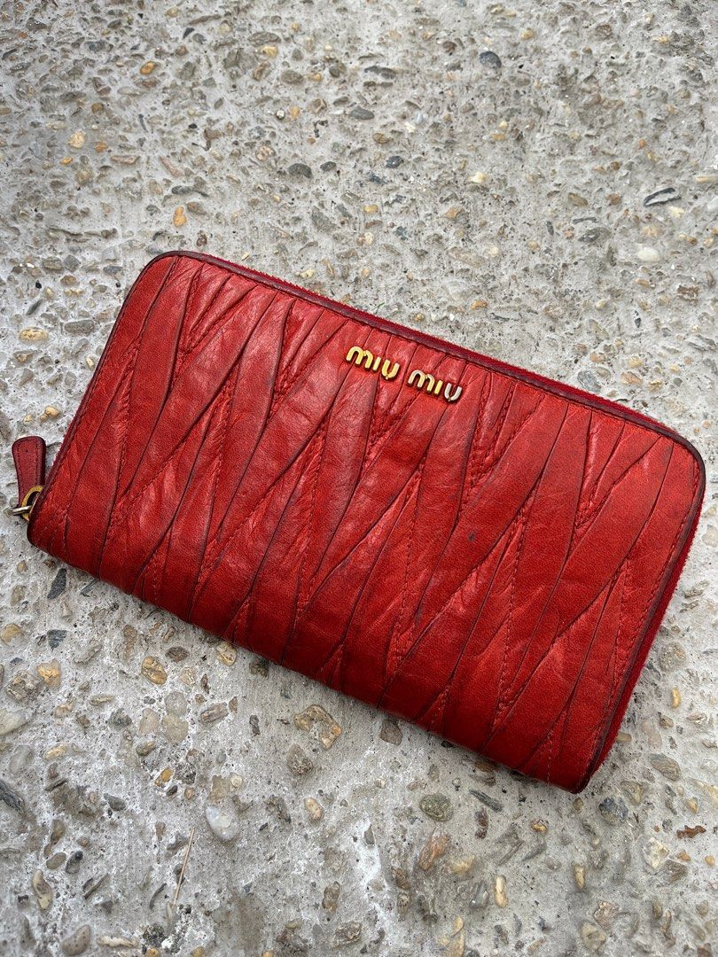 Miu Miu Long Wallet in Matelasse Leather (Category: Luxury Bags & Wallets) located in Dasmarinas. Submitted by bandananowheree (Listing ID 1415636244, Image 1). Description: Miu Miu Long Wallet in Matelasse Leather Iconic Miu Miu zip-around wallet crafted in rich red matelassé leather. Features the brand’s signature ruched quilting with gold-tone logo hardware. Soft, supple leather with natural character from use. Timeless archive piece that adds