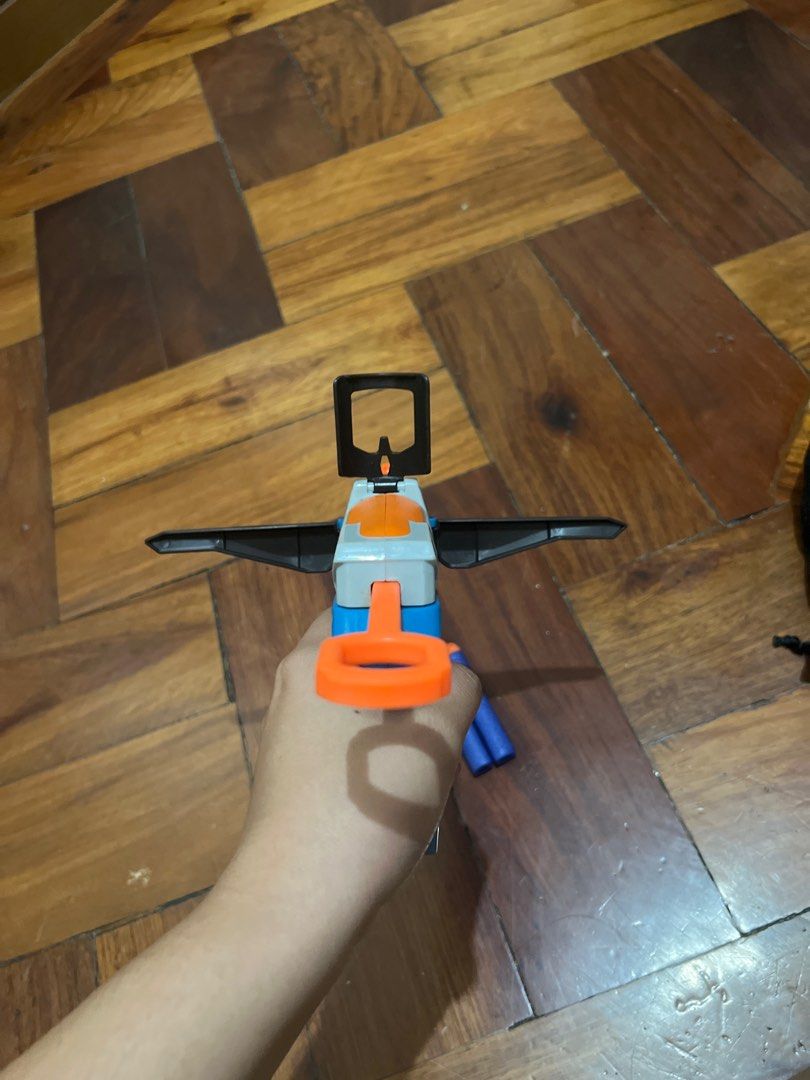 Nerf Crossbow Toy Gun (Category: Action & Battle Toys) located in Manila. Submitted by janaekpaj41634 (Listing ID 1415767474, Image 2). Description: RFS: decluttering; not in use Damages: No visible damage on gun itself, but the darts have minor dents. Payment: Upfront, negotiable price - Nerf crossbow toy gun - Includes 3 darts - Color scheme: Blue, orange, and gray - Features a sight and handle - In good working condition - Ready for play.