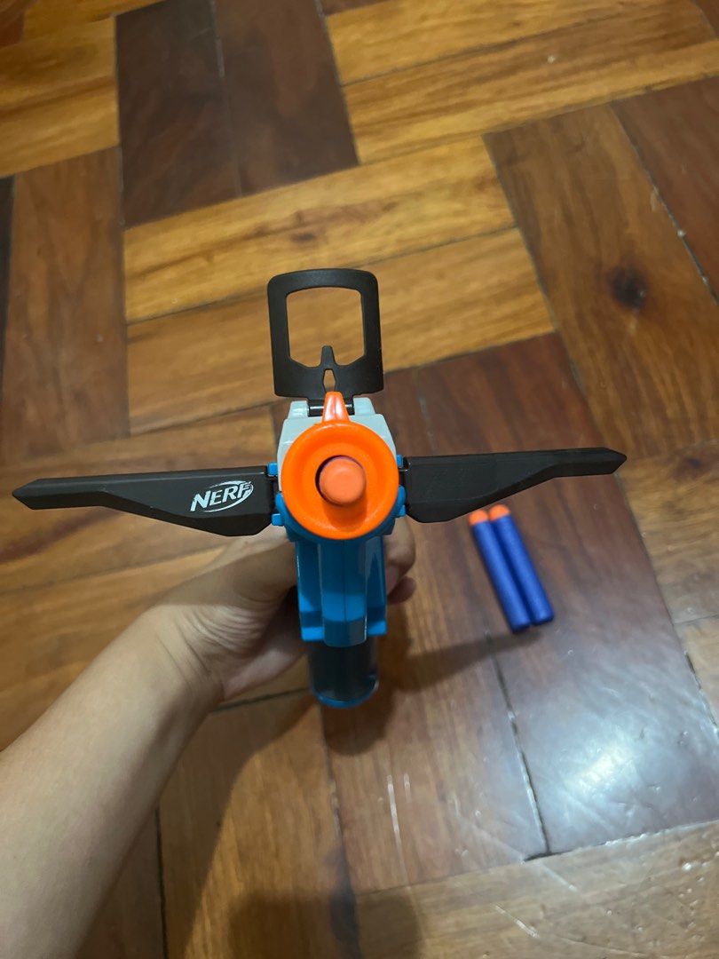 Nerf Crossbow Toy Gun (Category: Action & Battle Toys) located in Manila. Submitted by janaekpaj41634 (Listing ID 1415767474, Image 3). Description: RFS: decluttering; not in use Damages: No visible damage on gun itself, but the darts have minor dents. Payment: Upfront, negotiable price - Nerf crossbow toy gun - Includes 3 darts - Color scheme: Blue, orange, and gray - Features a sight and handle - In good working condition - Ready for play.