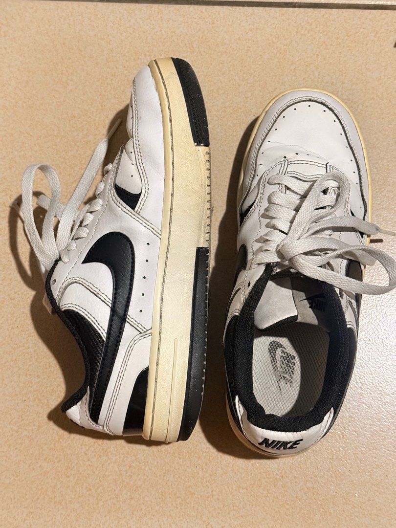 Nike Court Vision Low Sneakers (Category: Sneakers) located in Quezon City. Submitted by jazsolian (Listing ID 1415749566, Image 3). Description: - Nike Court Vision Low sneakers - Color: White with black accents - Nike logo on the side - "NIKE" branding on the heel - Cream-colored soles - White laces, black interior.